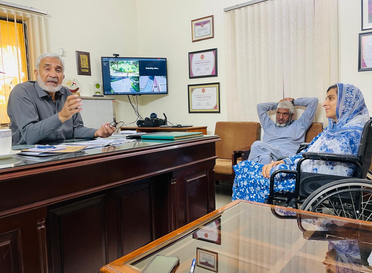 Momina Abbasi in a meeting with two men in an office.
